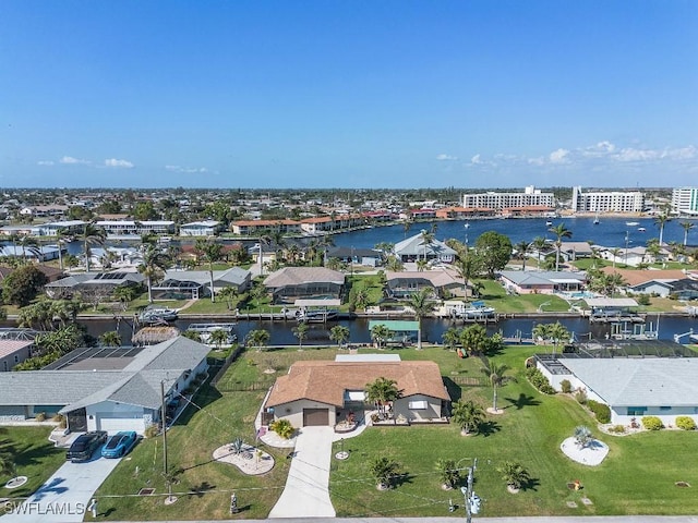 drone / aerial view with a water view and a residential view