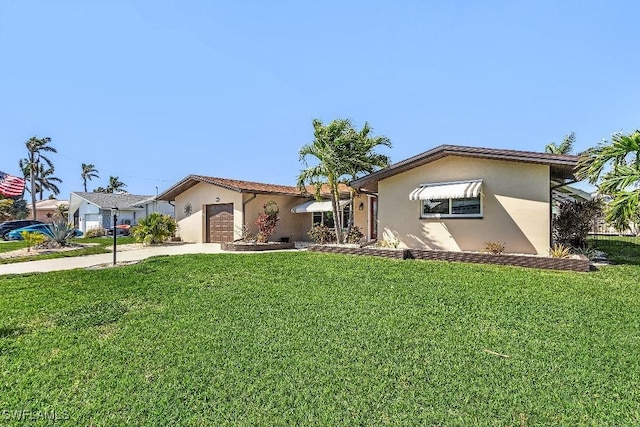 view of front of home featuring an attached garage, stucco siding, concrete driveway, and a front yard