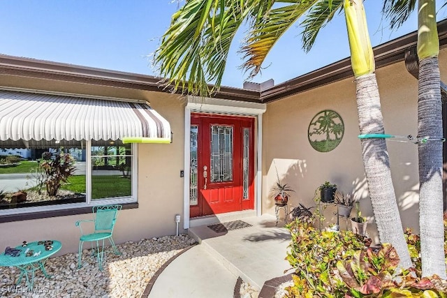 property entrance with stucco siding