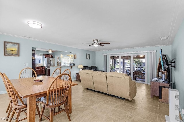 dining area featuring crown molding, visible vents, and a ceiling fan