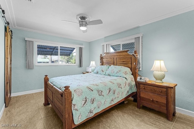 bedroom with ornamental molding, a ceiling fan, baseboards, and a barn door