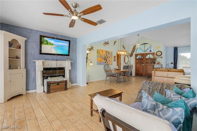 living room featuring light hardwood / wood-style flooring, ceiling fan, and lofted ceiling