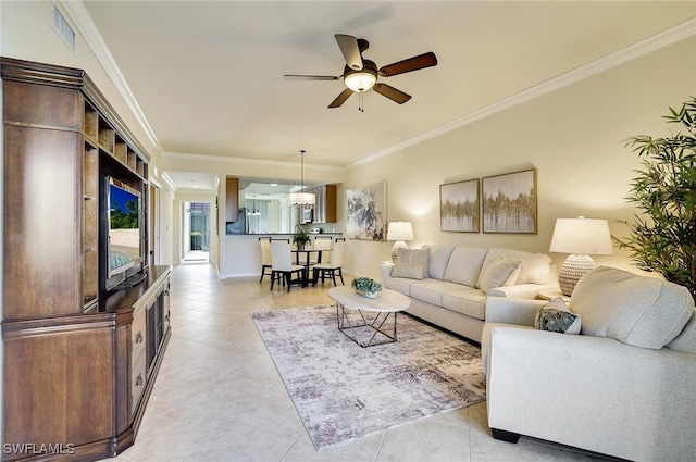 living area with light tile patterned floors, visible vents, crown molding, and ceiling fan