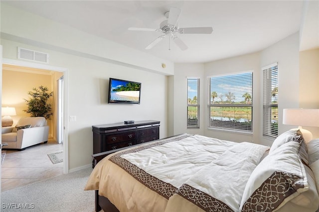 carpeted bedroom featuring baseboards, visible vents, and a ceiling fan