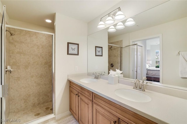 ensuite bathroom featuring tiled shower, a sink, and ensuite bath