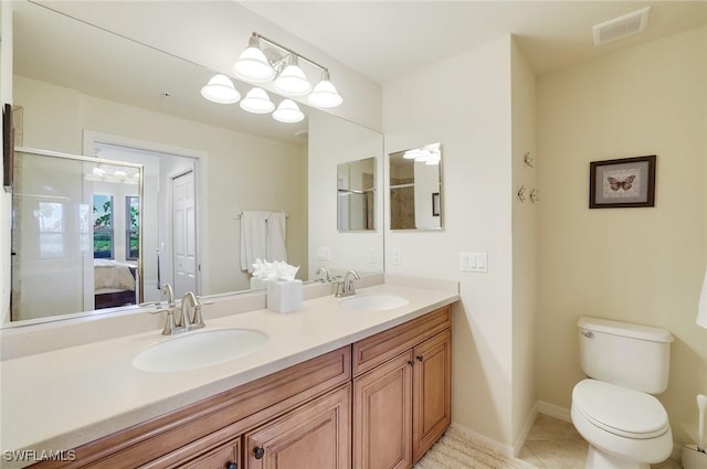 ensuite bathroom with toilet, tile patterned flooring, visible vents, and a sink