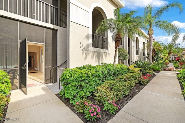 property entrance with stucco siding