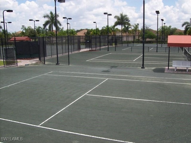 view of tennis court featuring fence