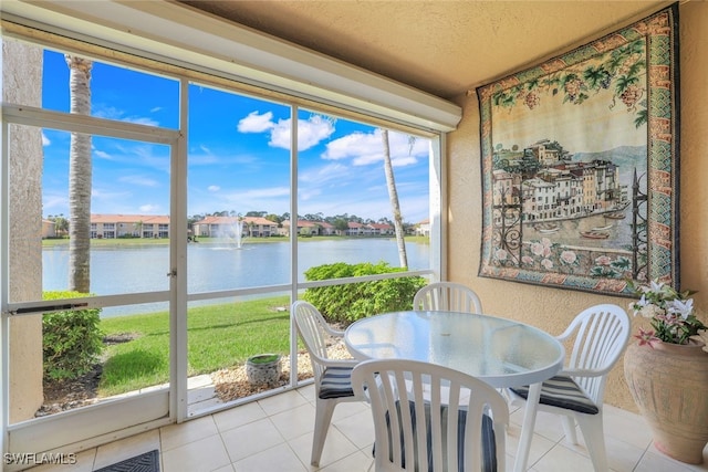 sunroom / solarium with a water view and a wealth of natural light