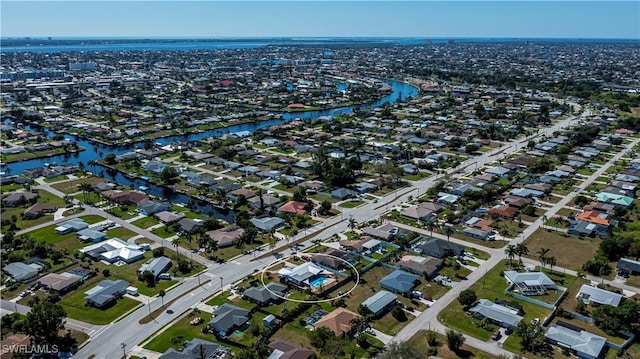 bird's eye view featuring a water view and a residential view