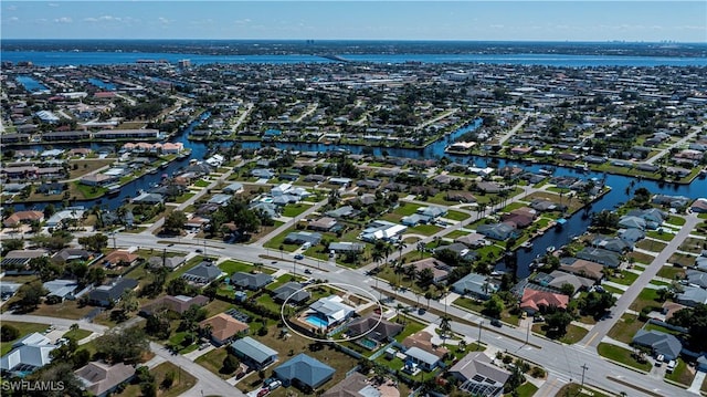 drone / aerial view with a water view and a residential view