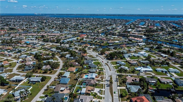 drone / aerial view featuring a residential view and a water view