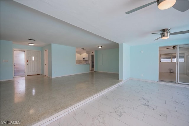 unfurnished room with marble finish floor, ceiling fan, visible vents, and baseboards