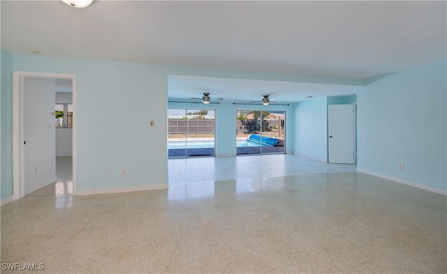 empty room with baseboards and light speckled floor