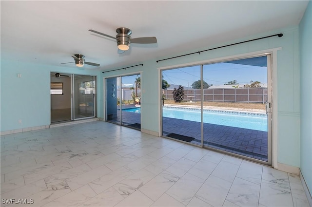 interior space with ceiling fan