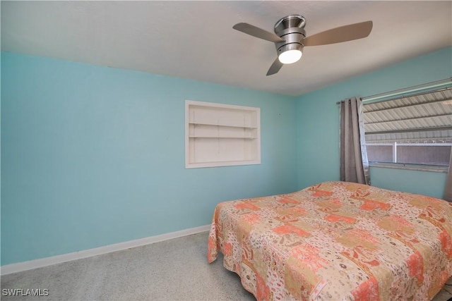 bedroom with a ceiling fan and baseboards