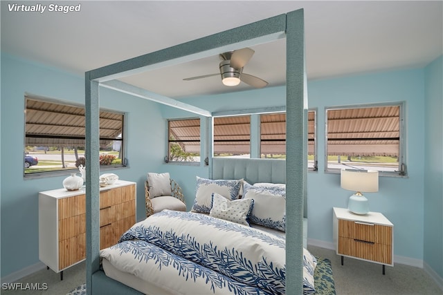 bedroom with a ceiling fan, carpet, and baseboards