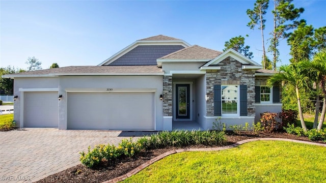 view of front of house with a garage and a front yard