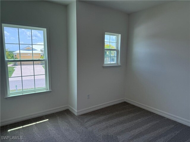 2211 Harbour Dr, Punta Gorda, FL 33983 - empty room featuring dark colored carpet and baseboards