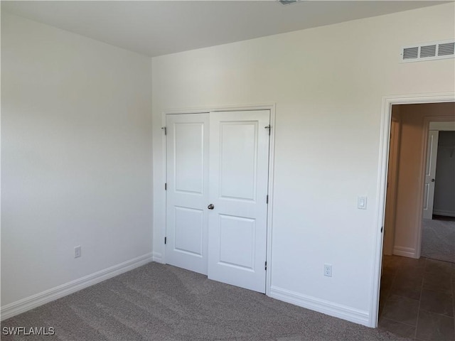 2211 Harbour Dr, Punta Gorda, FL 33983 - unfurnished bedroom featuring a closet, baseboards, and carpet floors