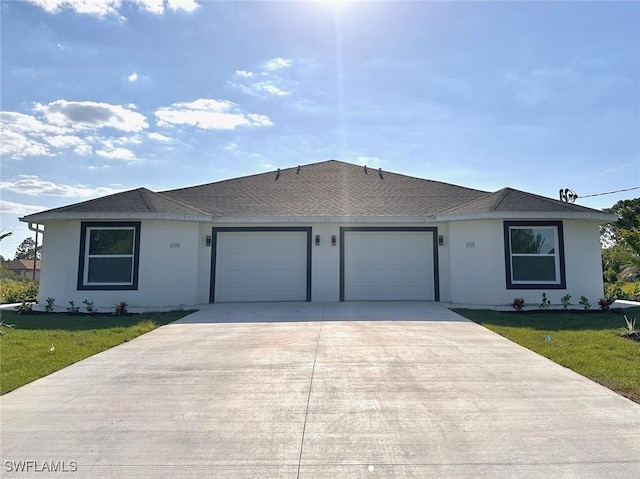 ranch-style home featuring a garage and a front lawn