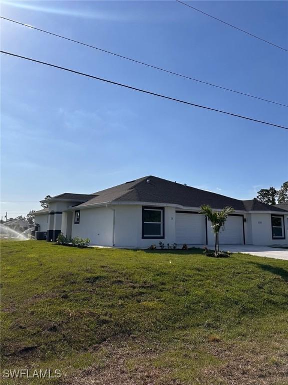 view of property exterior with a garage and a yard