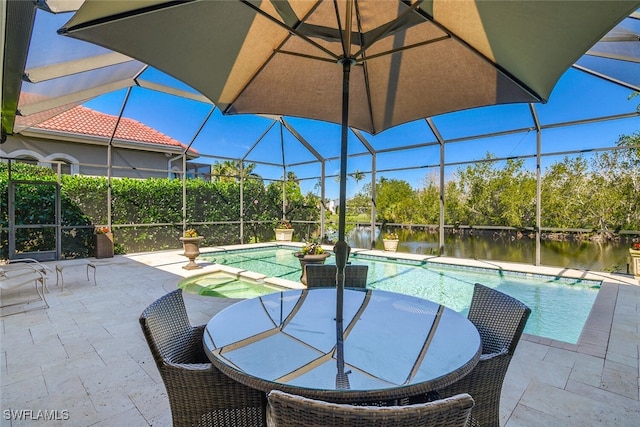 pool featuring a lanai, a patio area, an outdoor hot tub, and a water view