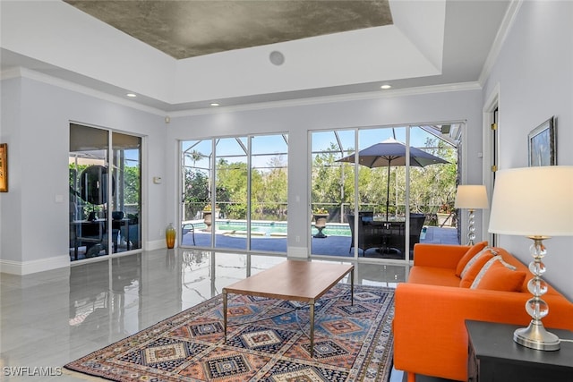 living area with a tray ceiling, ornamental molding, a sunroom, and baseboards