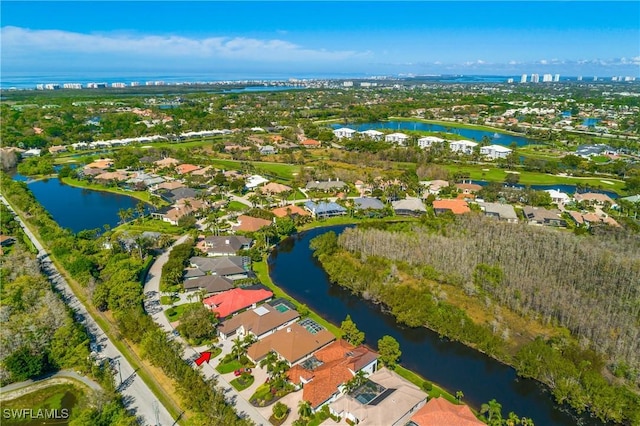 drone / aerial view with a water view and a residential view