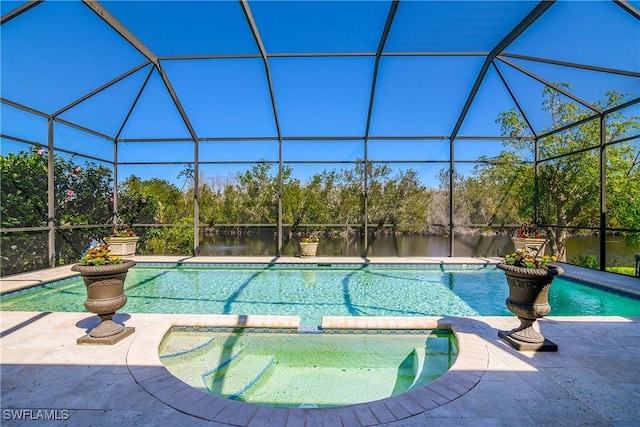 view of pool featuring glass enclosure, a patio area, and a pool with connected hot tub