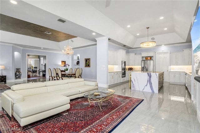 living room with a tray ceiling, visible vents, recessed lighting, and an inviting chandelier