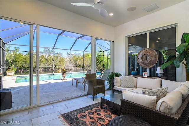 sunroom featuring ceiling fan