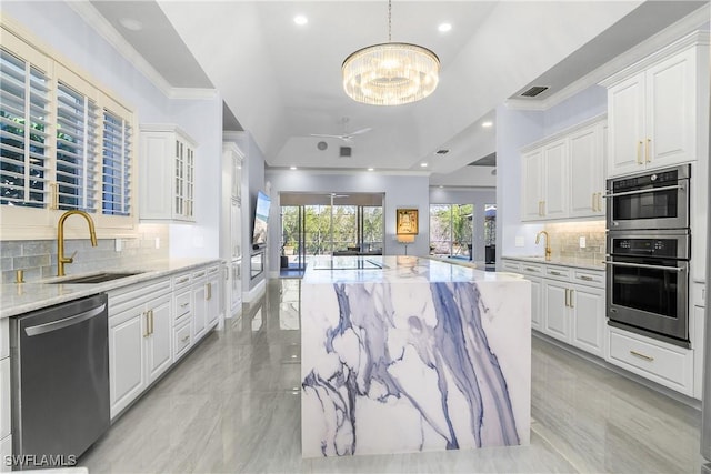 kitchen with visible vents, light stone countertops, ornamental molding, appliances with stainless steel finishes, and a sink