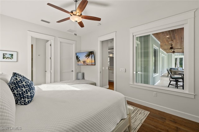 bedroom featuring access to exterior, visible vents, dark wood-type flooring, a ceiling fan, and baseboards