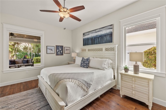 bedroom with a ceiling fan, dark wood-style flooring, and baseboards