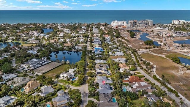 birds eye view of property featuring a water view and a residential view