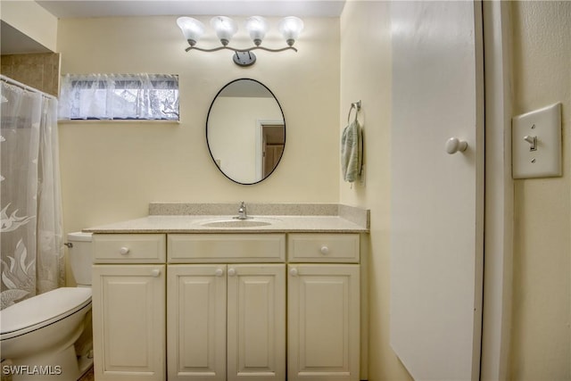 full bath featuring curtained shower, vanity, and toilet