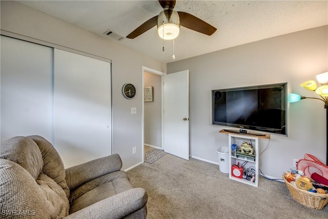 living room with visible vents, ceiling fan, light carpet, and baseboards