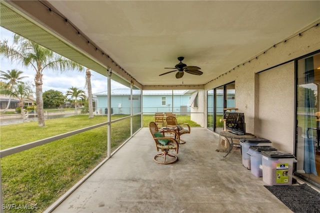 sunroom featuring ceiling fan