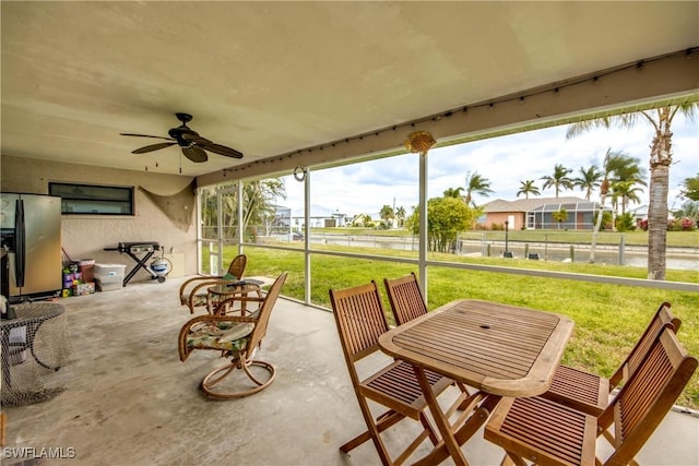 view of patio / terrace featuring ceiling fan, fence, and outdoor dining area