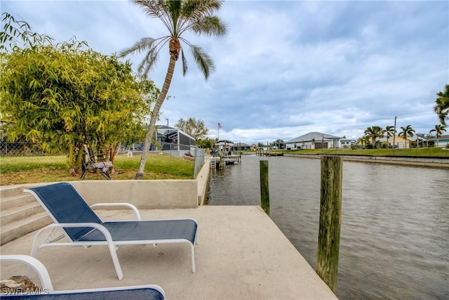 dock area with a residential view and a water view