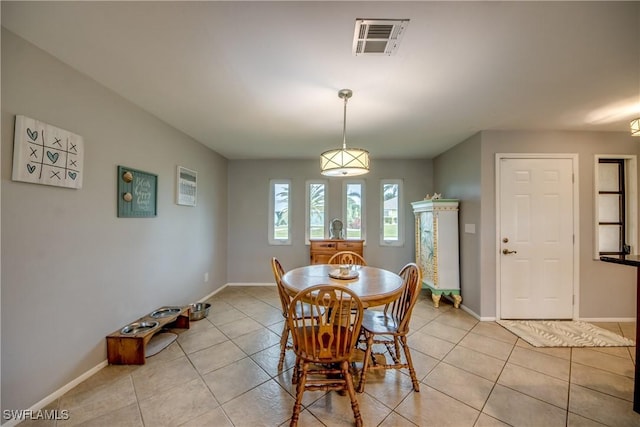 dining room with light tile patterned floors, visible vents, and baseboards