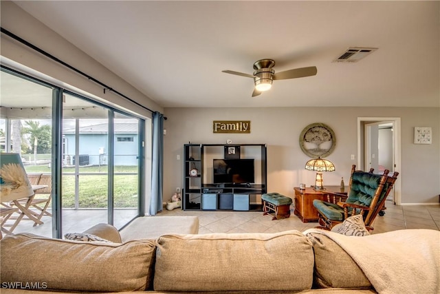 living area featuring plenty of natural light, light tile patterned flooring, and visible vents