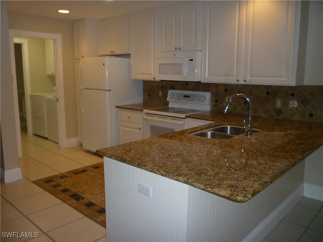 6210 Towncenter Cir, Naples, FL 34119 - kitchen featuring light tile patterned floors, white cabinets, a sink, white appliances, and a peninsula