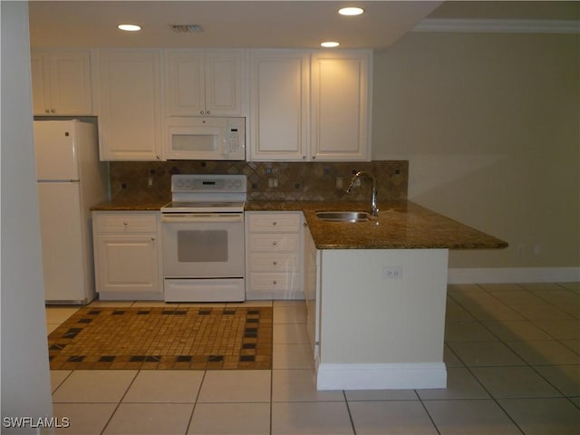 6210 Towncenter Cir, Naples, FL 34119 - kitchen featuring white appliances, a peninsula, white cabinetry, a sink, and light tile patterned flooring