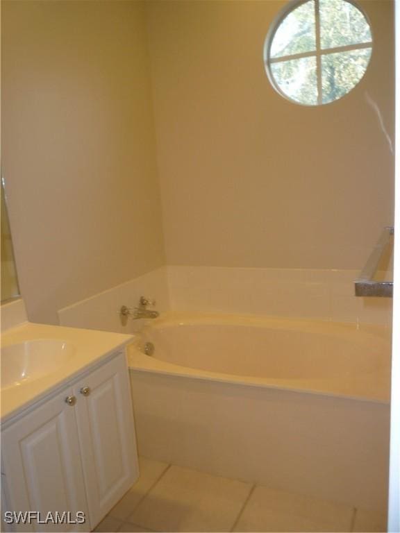 6210 Towncenter Cir, Naples, FL 34119 - full bathroom featuring a garden tub, tile patterned flooring, and vanity