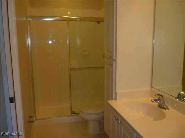 6210 Towncenter Cir, Naples, FL 34119 - bathroom with toilet, a shower stall, vanity, and tile patterned floors