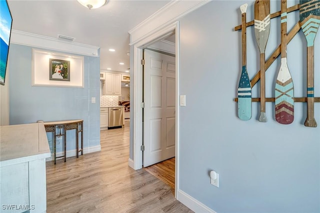 corridor featuring baseboards, visible vents, light wood-style floors, and recessed lighting