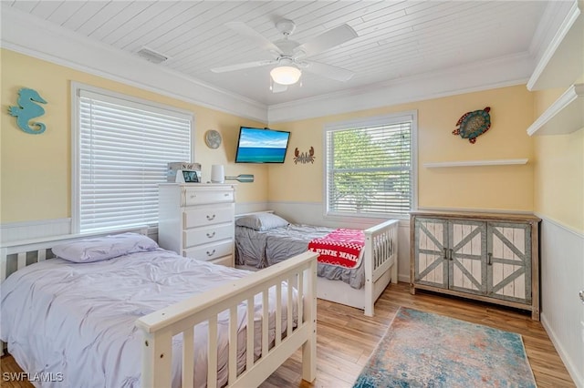 bedroom featuring visible vents, ornamental molding, and wood finished floors