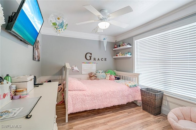 bedroom with a ceiling fan, ornamental molding, and light wood-type flooring